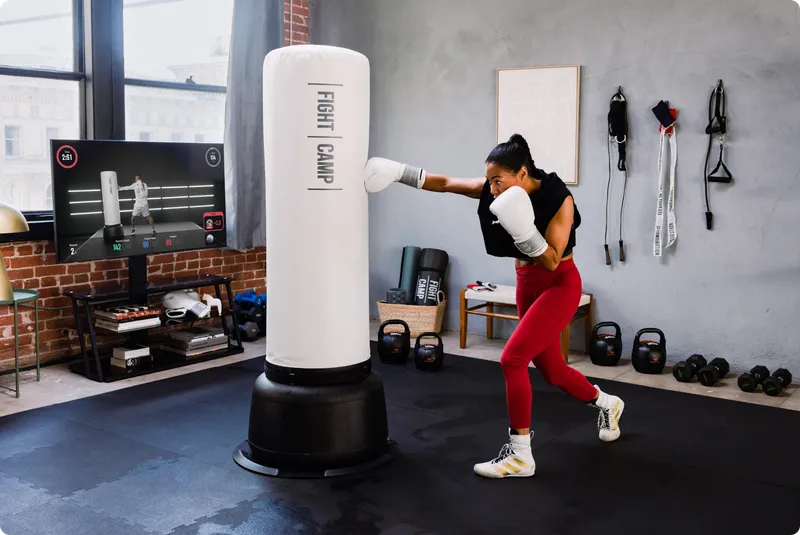 Woman punching the FightCamp bag